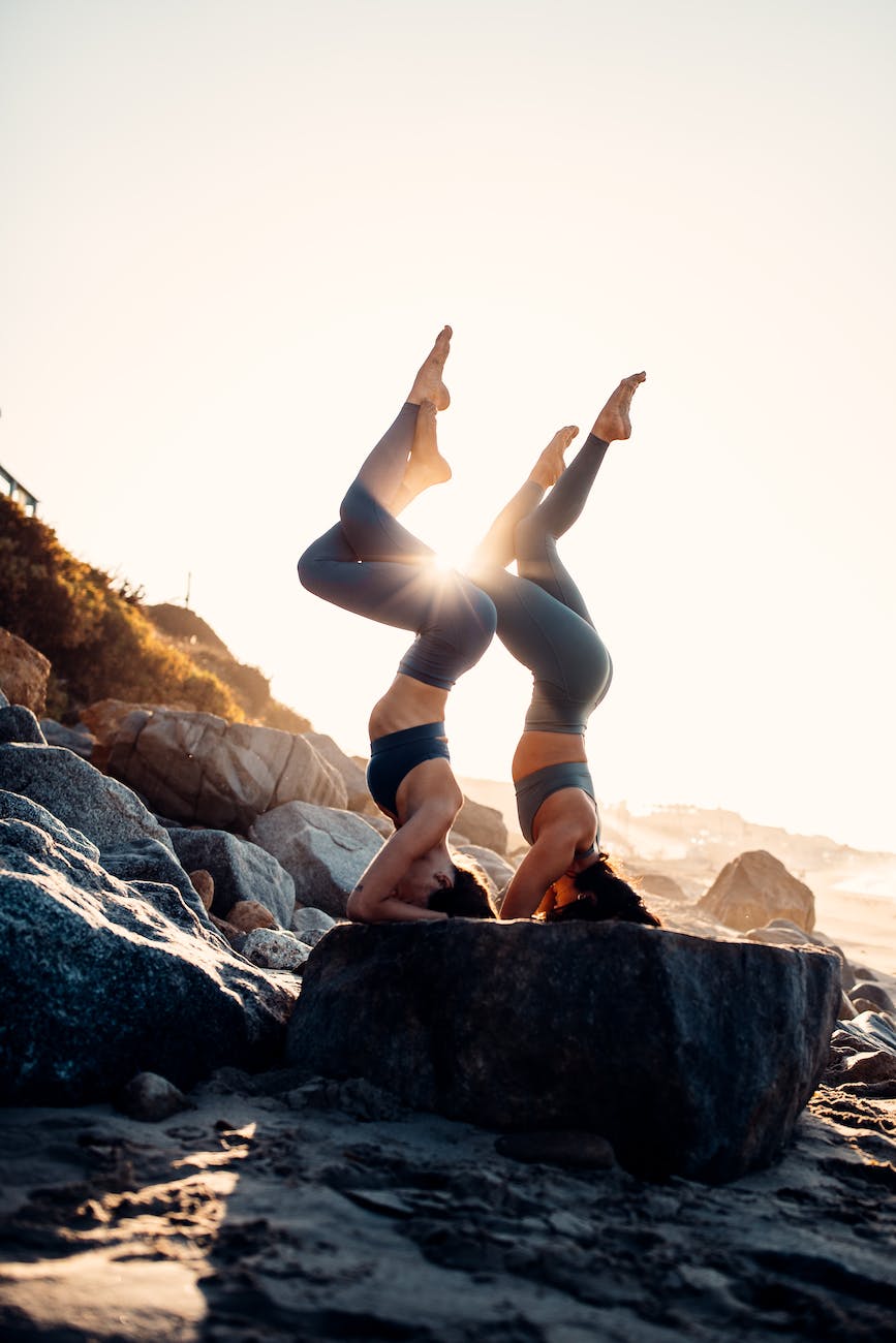 women doing acro yoga together