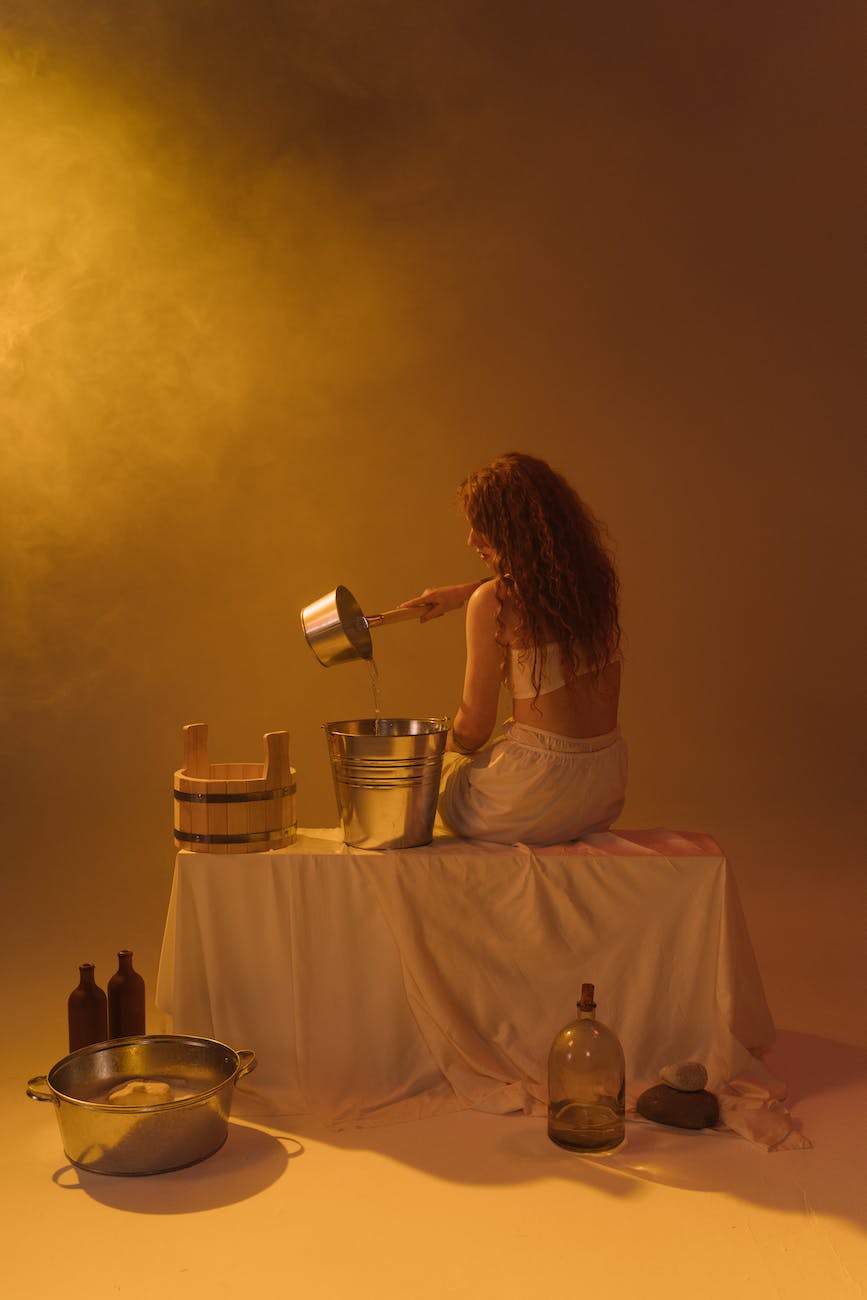 woman pouring water on a bucket